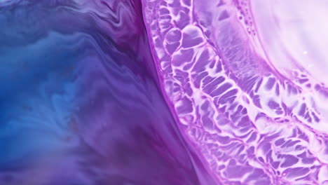 Vivid-purple-and-blue-ink-swirling-dynamically-in-water,-creating-abstract-patterns