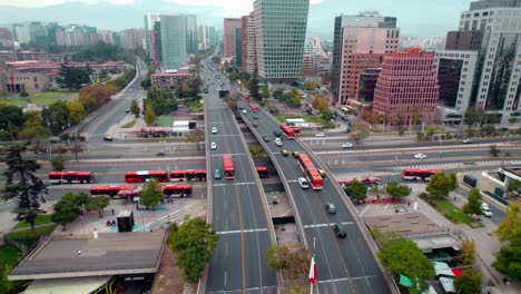 Aerial-drone-zooms-vibrant-cityscape-Santiago-de-Chile-Escuela-Militar-Station