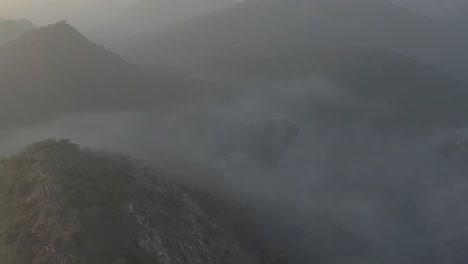 drone-Camara-is-heading-towards-the-side-where-the-mountains-are-visible-above-the-cloud