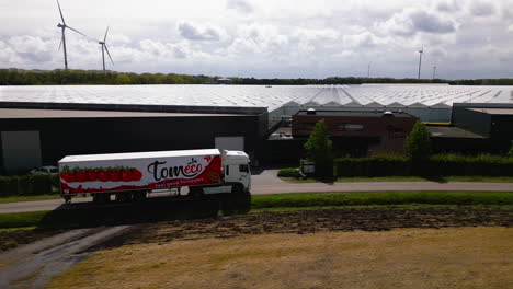 Tomato-truck-arriving-to-pick-up-good-for-export,-aerial-drone-view