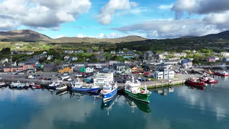 Drone-West-Cork-Castletownbere-fishing-port-with-busy-market-town-and-mountain-in-background-One-of-Irelands-most-important-fishing-ports-on-a-bright-May-Day