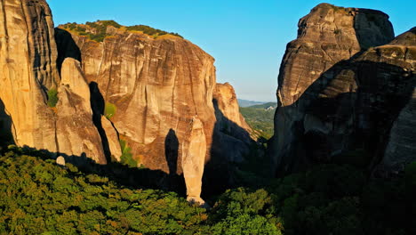 Meteora,-Greece,-Aerial-View-of-Scenic-Steep-Cliff,-Home-of-Orthodox-Monasteries-on-Golden-Hour-Sunlight