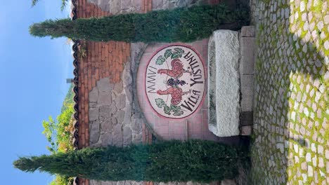 Beautiful-wall-fountain-with-stone-trough-and-mosaic-medallion