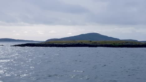 Scenic-view-of-remote,-rugged-and-rocky-island-traveling-to-Eriskay-on-South-Uist-in-the-Outer-Hebrides-of-Scotland-UK