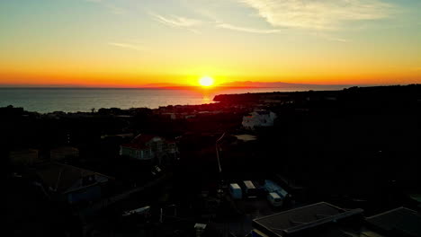 Sunrise-flying-towards-sun-rising-over-ocean-sea-water-clear-sky