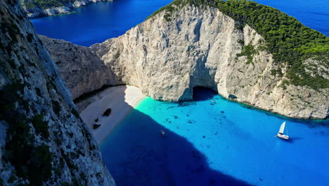 Zakynthos-Island,-Greece,-Aerial-View-of-Iconic-Navagio-Beach,-Isolated-With-Steep-Cliffs,-Drone-Shot