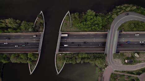 Steady-top-down-aerial-view-of-submerged-highway-with-traffic-passing-underneath-Veluwemeer-aquaduct-seen-from-above