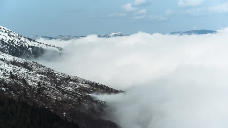 Time-Lapse-White-Foggy-Clouds-Floating-By-A-Mountain-Slope-sunny-day