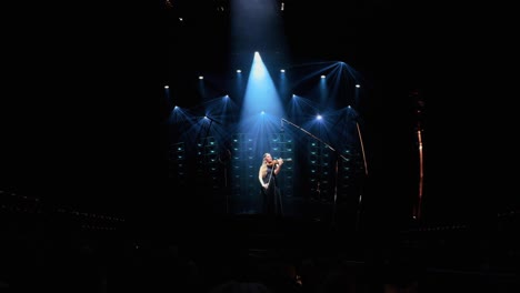 Violinist-Performing-on-Stage-Screened-At-The-Sphere-In-The-Las-Vegas-Valley,-Nevada,-USA