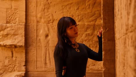 Cleopatra-lookalike-tourist-visits-the-Philae-temple-complex-and-admires-hieroglyphs