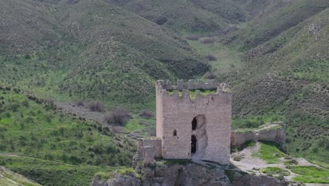 Drohnenflug-über-Die-Burg-Von-Ear-Aus-Dem-9.-Jahrhundert,-Mit-Fokus-Auf-Den-Bergfried,-Gefolgt-Von-Einer-Kamerafahrt-Mit-Hängen-Mit-Wegen-Und-Vegetation-Im-Hintergrund,-Gefilmt-In-70-Mm