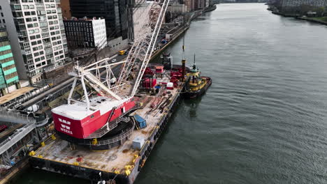 Aerial-view-of-a-Barge-Mounted-Heavy-Crane-and-a-construction-vessel-on-the-NYC-waterfront