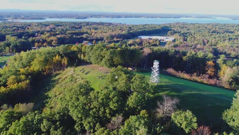 Drone-orbit-counterclockwise-of-Stratham-fire-tower-in-Stratham,-NH-during-golden-hour-in-early-fall