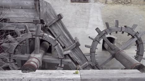 Wooden-gears-of-an-old-mill-in-the-Town-of-Laatsch---Laudes,-Vinschgau,-South-Tyrol,-Italy