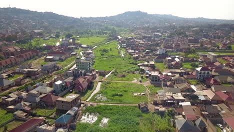 Grassy-area-with-canal-and-bridges,-streets-of-Bukasa-in-Kampala,-Uganda