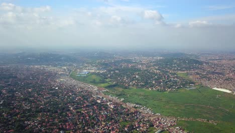 Wide-aerial-view-of-Bukasa-and-Kampala-populated-area,-Uganda