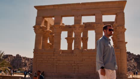 People-visiting-Trajan's-Kiosk-of-the-Philae-Temple-by-the-Nile,-Aswan,-Egypt