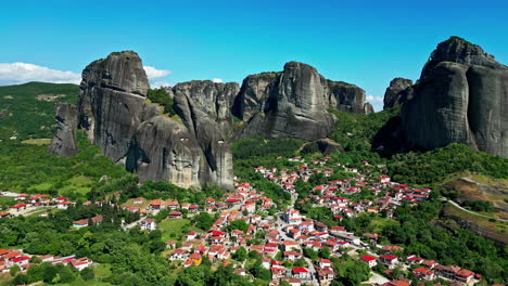 Rückwärts-Gedrehte-Luftdrohne-über-Der-Stadt-Kalambaka-Mit-Erodierten-Bergen-Im-Hintergrund-In-Griechenland-Bei-Tag