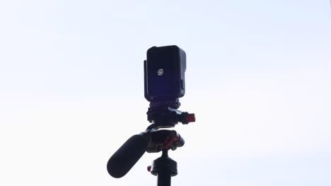 Close-up-of-Insta360-Ace-Pro-action-camera-with-clear-sky-in-background-for-copy-space