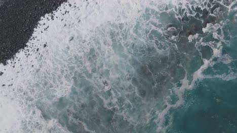 Drone-flight-over-the-wild-beach-with-black-rocks-and-big-waves-in-Madeira-Portugal