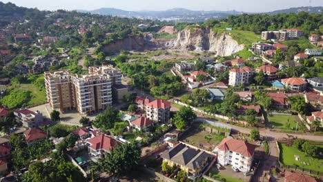 Amazing-drone-reveal-stone-quarry-and-residential-buildings,-urban-surroundings