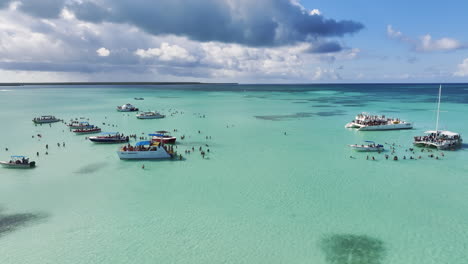 Yacht-And-Catamaran-With-Tourists-Swimming-On-Crystal-Clear-Water-Of-Sea-In-Dominican-Republic