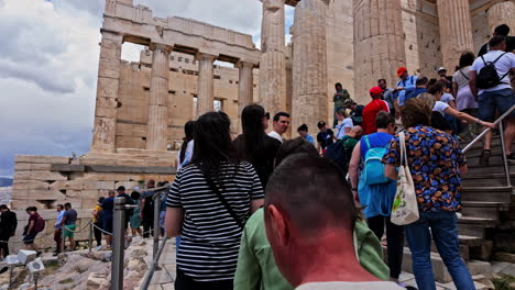 Crowd-of-people-walking-upwards-to-Acropolis-of-Athens,-slow-motion-view