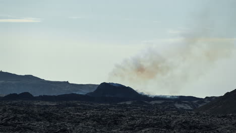 Smoke-rises-from-the-barren-landscape-of-Grindavik-Volcano,-capturing-a-moment-of-geological-activity