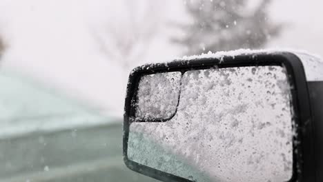 heavy-snowflakes-snow-falling-on-drivers-side-truck-mirror-in-a-winter-storm-60fps