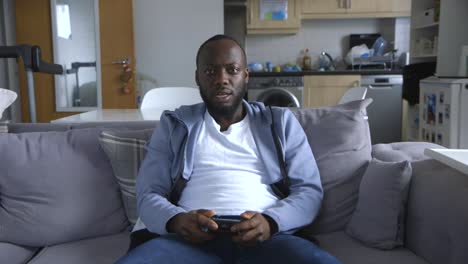 Black-Male-Competitively-Playing-Video-Games-In-Lounge-Room