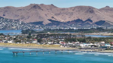 New-Brighton-suburb-with-the-pier-and-Richmond-Hill-on-background,-Christchurch