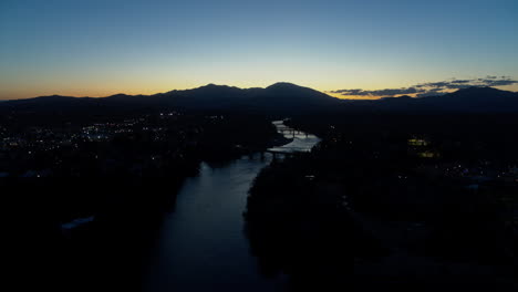 Aerial-footage-flying-towards-the-Sawtooth-Mountain-in-the-dusk-of-sunset-over-the-Sacramento-River-in-Redding,-California