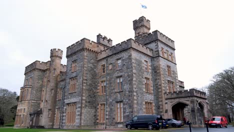 Exterior-view-of-Lews-Castle-flying-the-Scottish-flag-in-Stornoway,-Outer-Hebrides-of-Scotland-UK