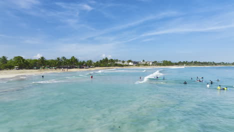 Surfers-Floating-On-Turquoise-Waters-Of-Bávaro-Beach-Resorts-In-Punta-Cana,-Dominican-Republic
