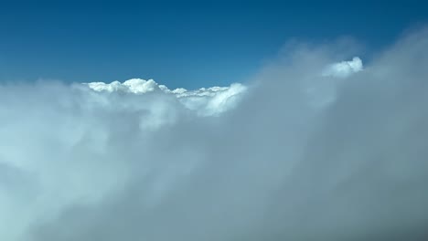 Immersive-pilot-POV-flying-across-a-blue-sky-plenty-of-clouds