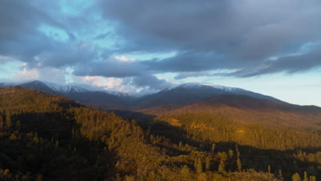 Aerial-pan-across-Sawtooth-Mountain-with-foothills-in-the-foreground-lit-by-the-light-of-the-sunrise-in-Redding,-California