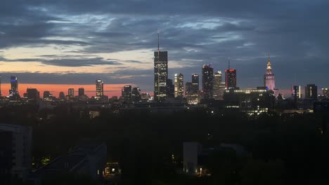 Beautiful-sunset-and-dark-clouds-over-downtown-of-skyscrapers-in-Warsaw,-Poland
