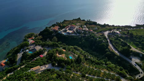 Luxury-villas-on-hilly-ocean-coastline,-aerial-drone-view