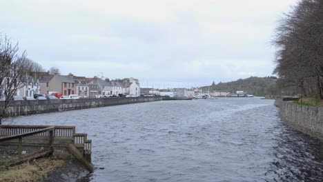 Scenic-view-overlooking-harbour-water,-houses,-and-traffic-in-Stornoway-town,-Outer-Hebrides-of-Scotland-UK