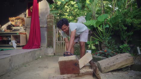 Asian-Wood-Carver-Uses-Chainsaw-In-Cutting-Wood-For-Balinese-Sculpture-Carving