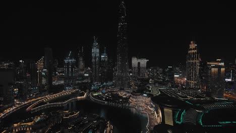 Establishing-shot-Dubai-downtown-skyline-at-blue-hour,-city-landscape-lighting-pan-up-Aerial-view