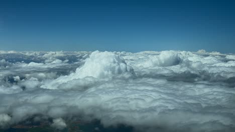 POV-flying-above-some-stormy-clouds,-as-seen-by-the-pilots-of-a-jet