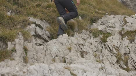 A-Man-is-Ascending-the-Challenging-Terrain-of-Monte-Resegone-in-Lombardy,-Italy---Tracking-Shot