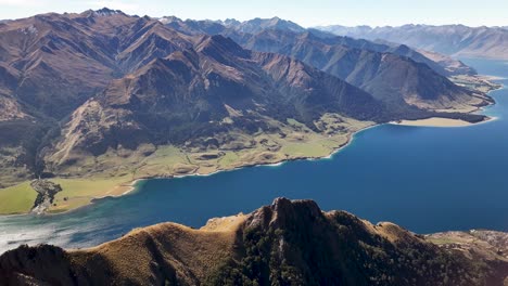 Beautiful-scenic-view-of-high-mountain-peaks-and-Lake-Hawea,-sunny-day-in-Otago,-New-Zealand