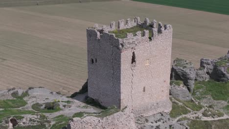 magnificent-orbital-flight-with-a-drone-over-the-9th-century-Oreja-castle-creating-a-visual-effect-by-filming-in-70mm-with-a-background-of-crop-fields-and-a-magnificent-location-of-the-fortress