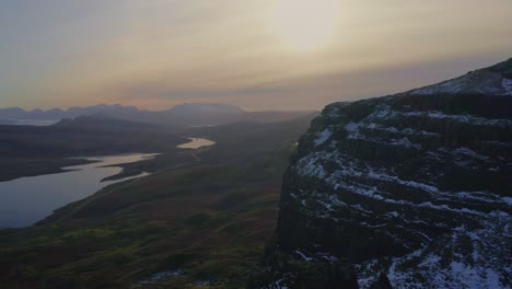 Golden-lights-bathe-the-Scottish-Highlands-and-the-Old-Man-of-Storr-rocky-peak,-Isle-of-Skye