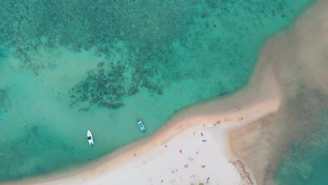 Aerials-drone-top-shot-of-a-beach-with-turquoise-clear-blue-water-in-Thailand-at-sunset