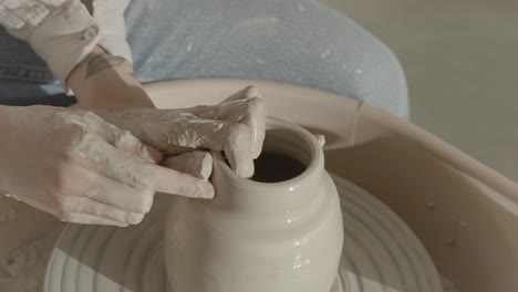 a-female-ceramicist-throwing-a-vase-on-the-pottery-wheel