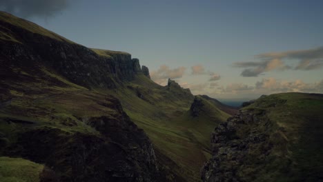 Flight-atop-a-ridge-reveals-a-steep-valley-on-the-Scottish-Highlands,-Quiraing-Walk,-Isle-of-Skye