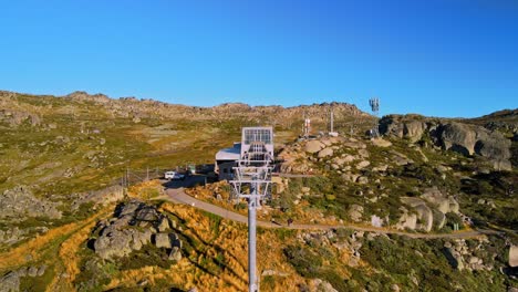 Tilt-drone-shot-of-closed-ski-chairlift-at-Thredbo-during-summer-in-Snowy-Mountains,-NSW,-Australia